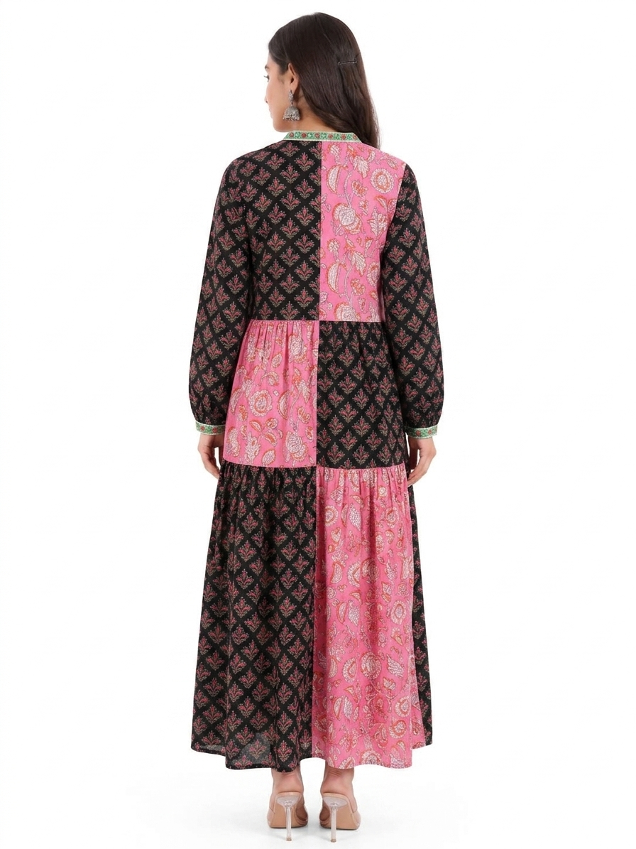 Woman wearing a black and pink patterned dress on a white background
