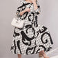 Monochrome Abstract Cotton Dress– Artistic Grid Print with High-Low Hem