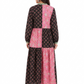 Woman wearing a black and pink patterned dress on a white background