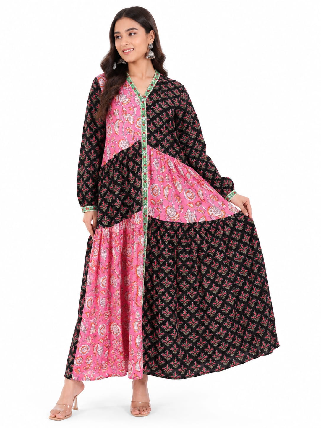 Woman wearing a black and pink patterned outfit on a white background