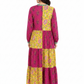 Back view of women in block print magenta purple and yellow tiered cotton maxi long dress showing paneled design
