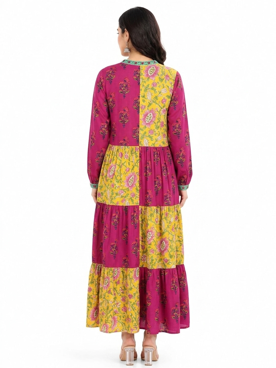 Back view of women in block print magenta purple and yellow tiered cotton maxi long dress showing paneled design