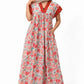 Woman wearing a floral dress with a plain background