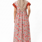 Woman wearing a floral dress with a beige hijab on a white background