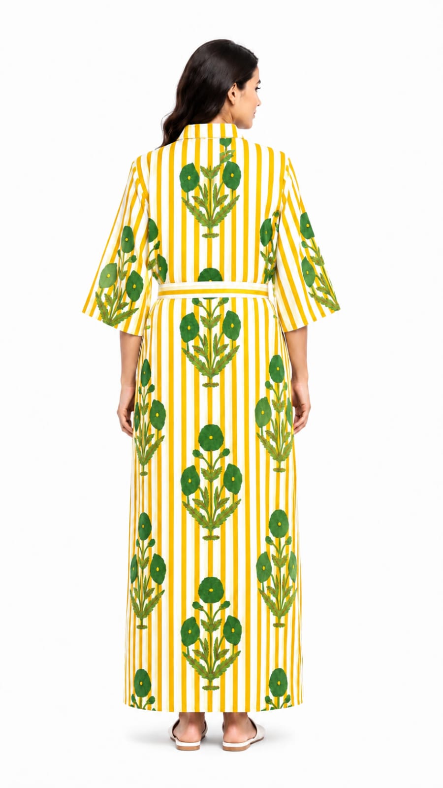 Woman wearing a yellow and green patterned dress on a white background