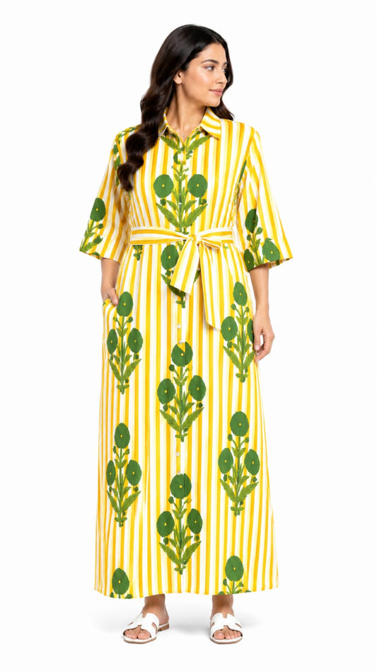 Woman wearing a yellow and green patterned dress on a white background