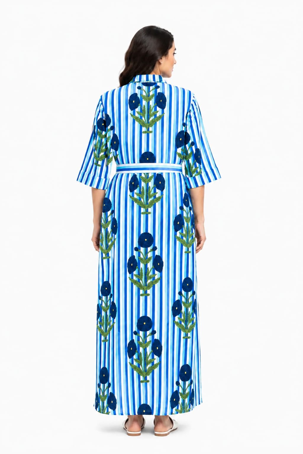 Woman wearing a blue and white striped dress with floral patterns on a white background
