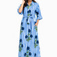 Woman wearing a blue and white striped dress with floral patterns on a white background