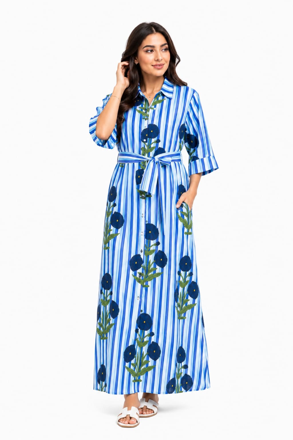 Woman wearing a blue and white striped dress with floral patterns on a white background