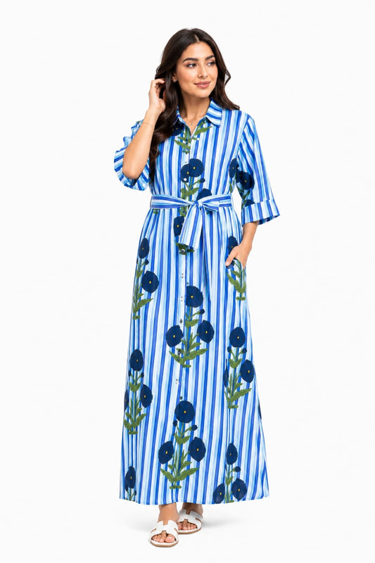 Woman wearing a blue and white striped dress with floral patterns on a white background