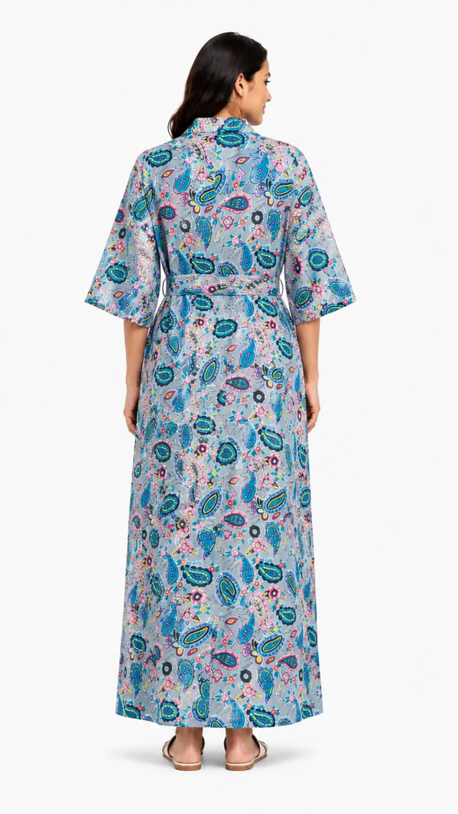 Woman wearing a long floral dress with a white background