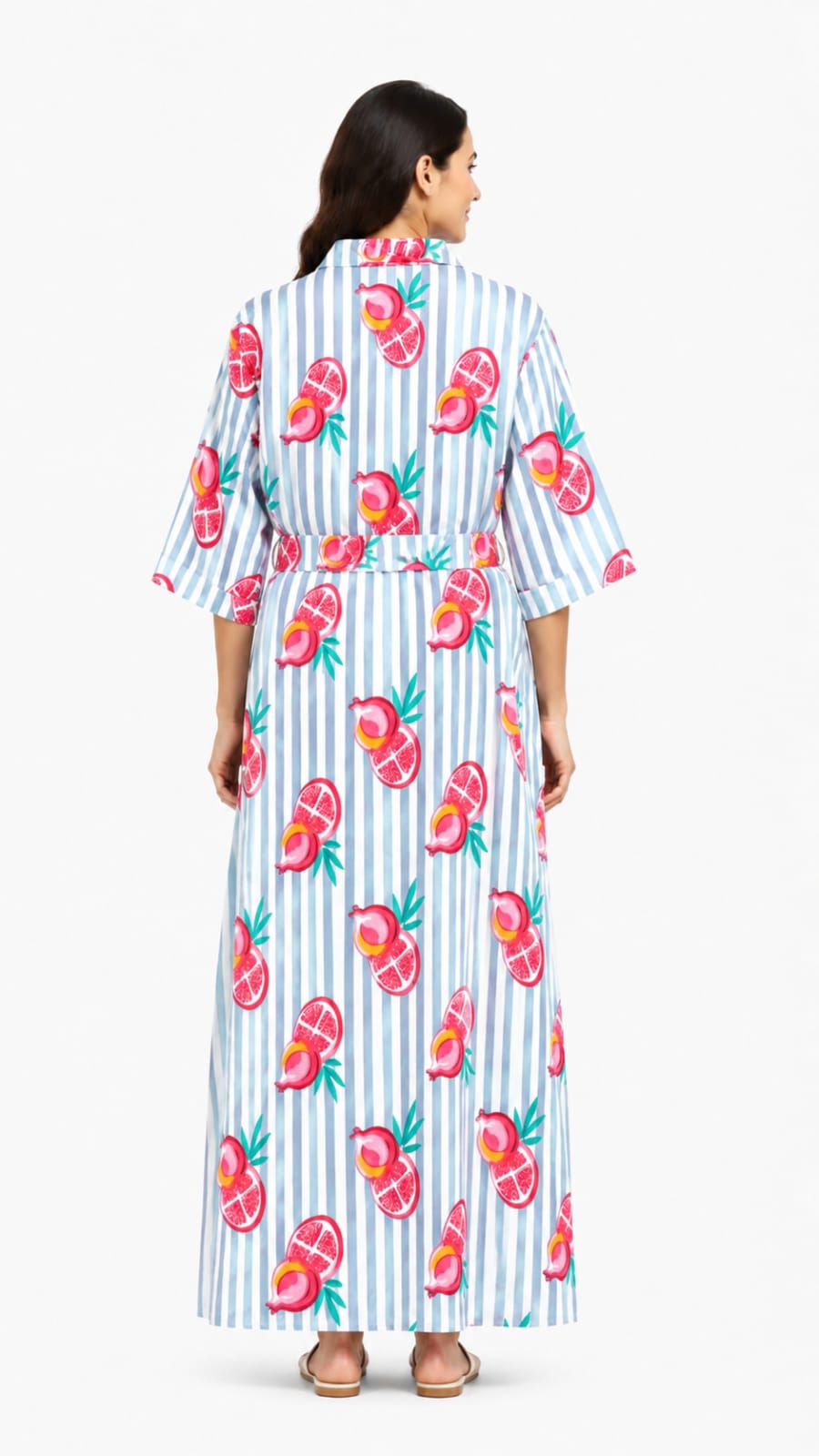 Woman wearing a long, patterned dress with a white background