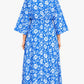 Woman wearing a blue floral dress on a white background