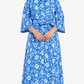 Woman wearing a blue floral dress on a white background