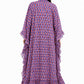 Back view of a model showcasing the flowing silhouette and cascading side ruffles of a blue block print long kaftan dress