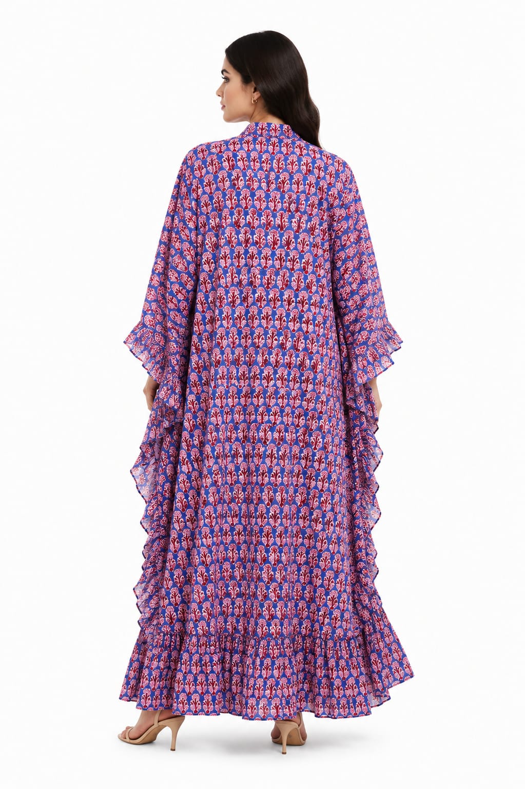 Back view of a model showcasing the flowing silhouette and cascading side ruffles of a blue block print long kaftan dress
