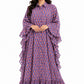 Front view of a model wearing a full length blue and red block print kaftan maxi dress featuring dramatic ruffle sleeves and a collared button down front