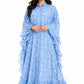 Woman wearing a blue floral dress with ruffled layers on a white background