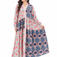 Woman wearing a long, patterned dress with floral and geometric designs on a white background