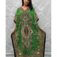 Woman wearing a green patterned dress against a white wall.