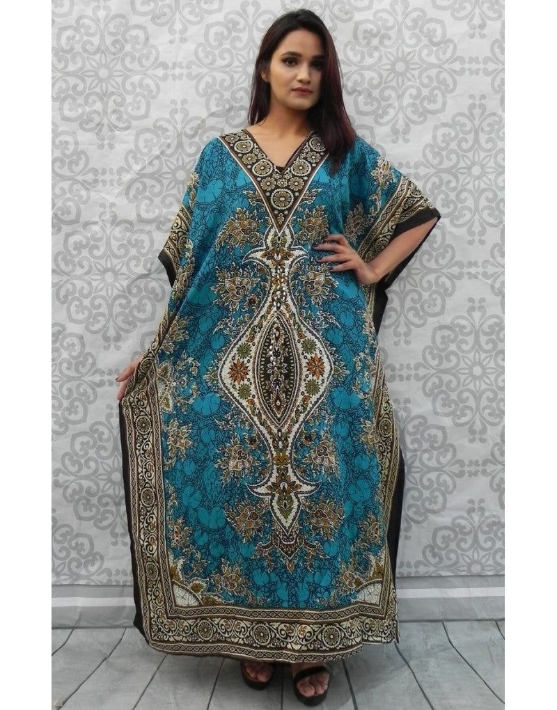 Woman wearing a blue patterned dress against a decorative wall.