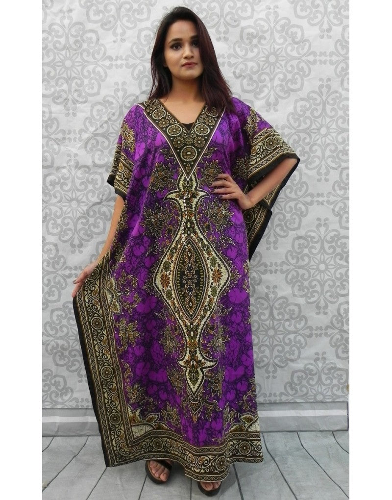 Woman wearing a purple and gold patterned dress against a decorative wall.